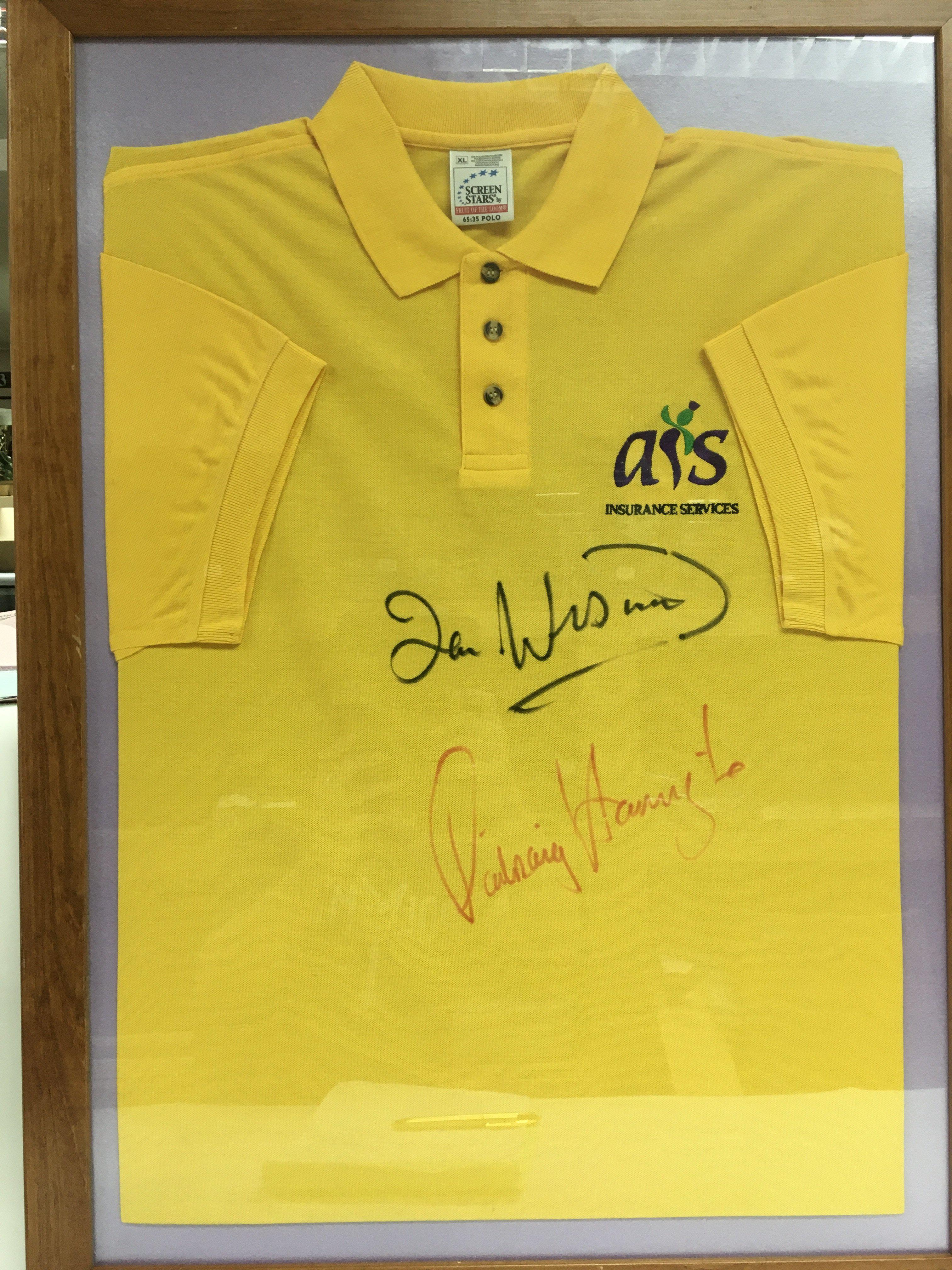 A framed and glazed golf shirt signed by Ian Woosnam and Padraig Harrington.