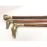 Three walking sticks with handles in the form of a