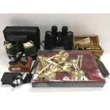 A collection of binoculars, student microscope, cased cutlery etc.