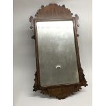 A walnut framed wall mirror, approx 69cm x 37cm.