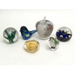 A collection of six decorative glass paperweights including Murano, Caithness and Wedgwood