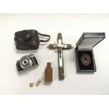 A miniature camera, brooch, crucifix inset with mother of pearl and prisoner of war hand made dice