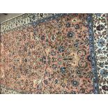 An Indian style carpet the central field with flowers and foilage with floral boarder. 280 cm by 178