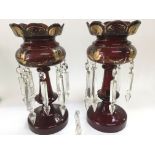 A pair of ruby glass lustres with giltwork decorat