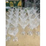 A collection of 24 cut glass wine glasses together