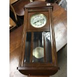 A 1950s wall clock with brass pendulum. Height is approximately 78cm. No reserve.