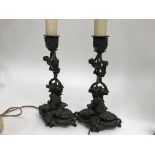 A pair of Bronze candle sticks of classical form d