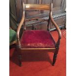 A William IV open arm chair with a drop in seat an