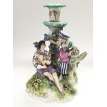 A Meissen figural candlestick of a gent and a lady