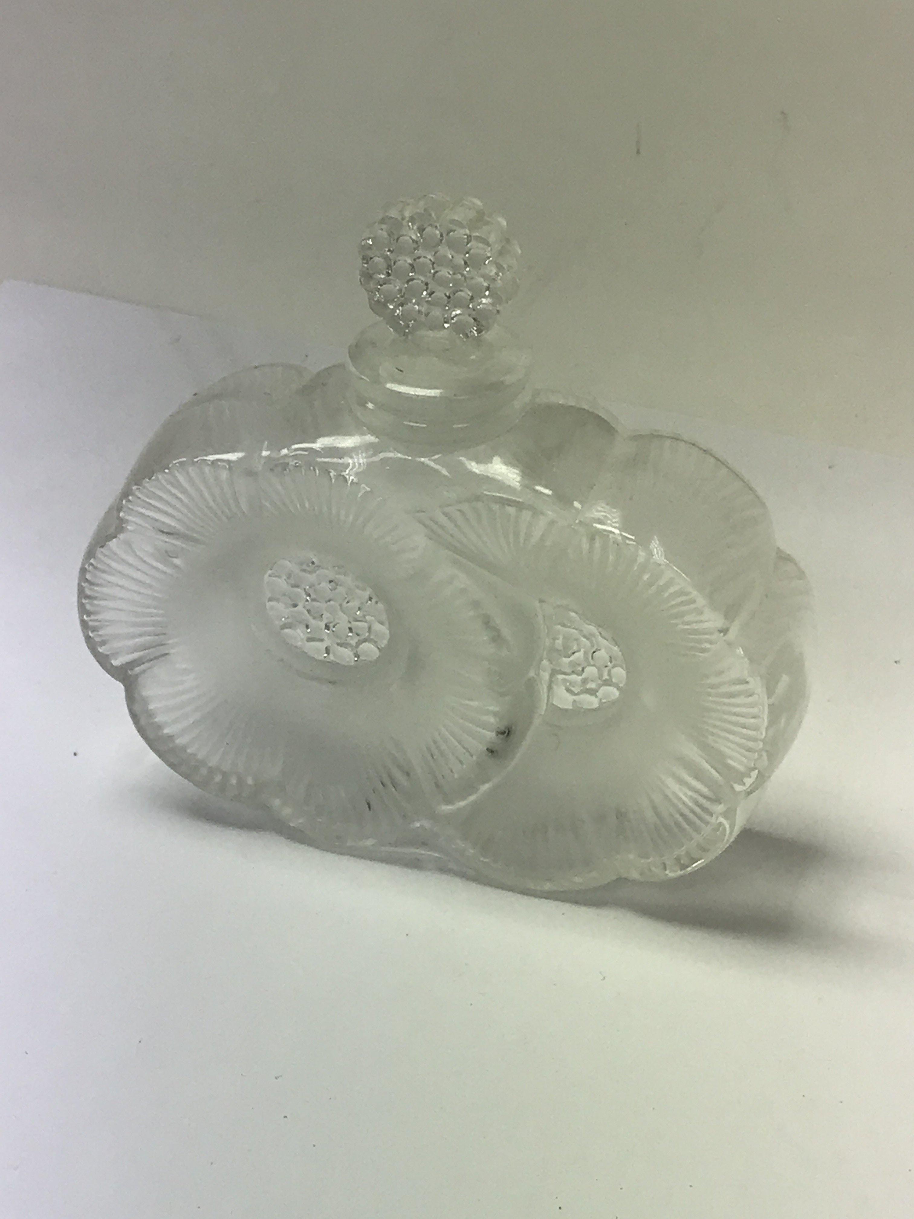 A Lalique perfume bottle in the form of flower hea