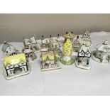 A collection of Coalport porcelain cottages of var