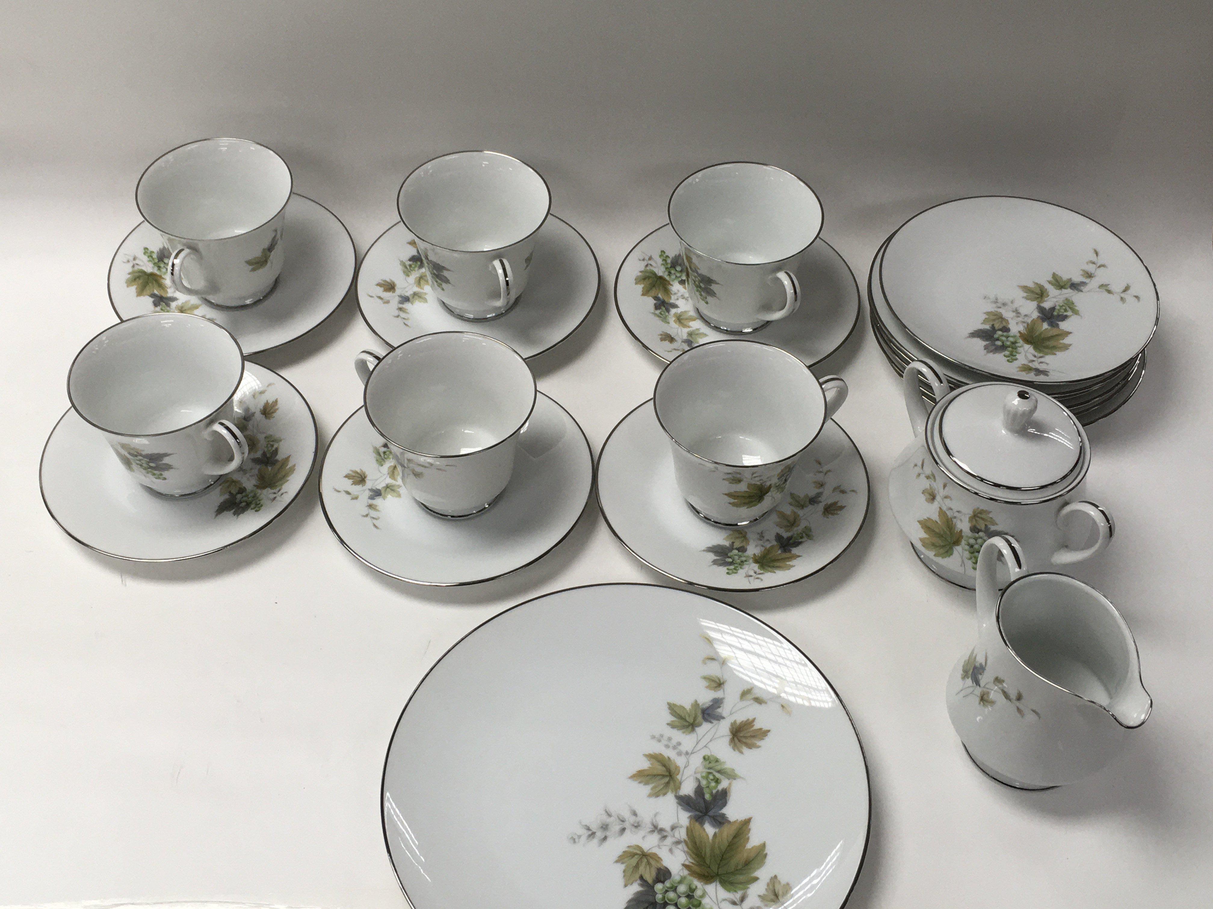 An RC Noritake porcelain tea set. 6 tea cups, 6 sa