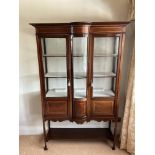 A 1920s upright glazed display cabinet with 3 glas