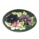 A Walter Moorcroft oval shaped dish in clematis pa