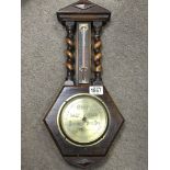 An oak cased barometer By Henry Hughes & Sons with