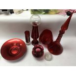 A collection of red glass ornamental items of mode