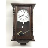 A wooden wall clock having Roman numerals and silvered dial