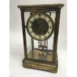 A late 19th century brass cased four glass clock w