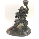 A bronzed figural candlestick of a Japanese warrio