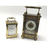 Two clocks. One is an ornate antique french carriage clock and the other A Lionel Peck of London