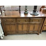 A low ercol sideboard. 142 x 51 x 85cm