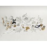 A collection of Swarovski glass ornaments including two hanging Christmas ornaments and conforming