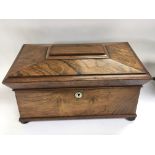 A quality rosewood tea caddy.