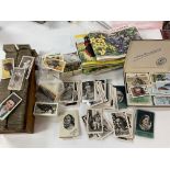 A varied collection of cigarette and tea cards including Toccos film cards, Churchmans, Carreras,