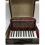 An accordion that is in its original box with leat