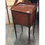 A late George III mahogany pot cupboard with turned legs.