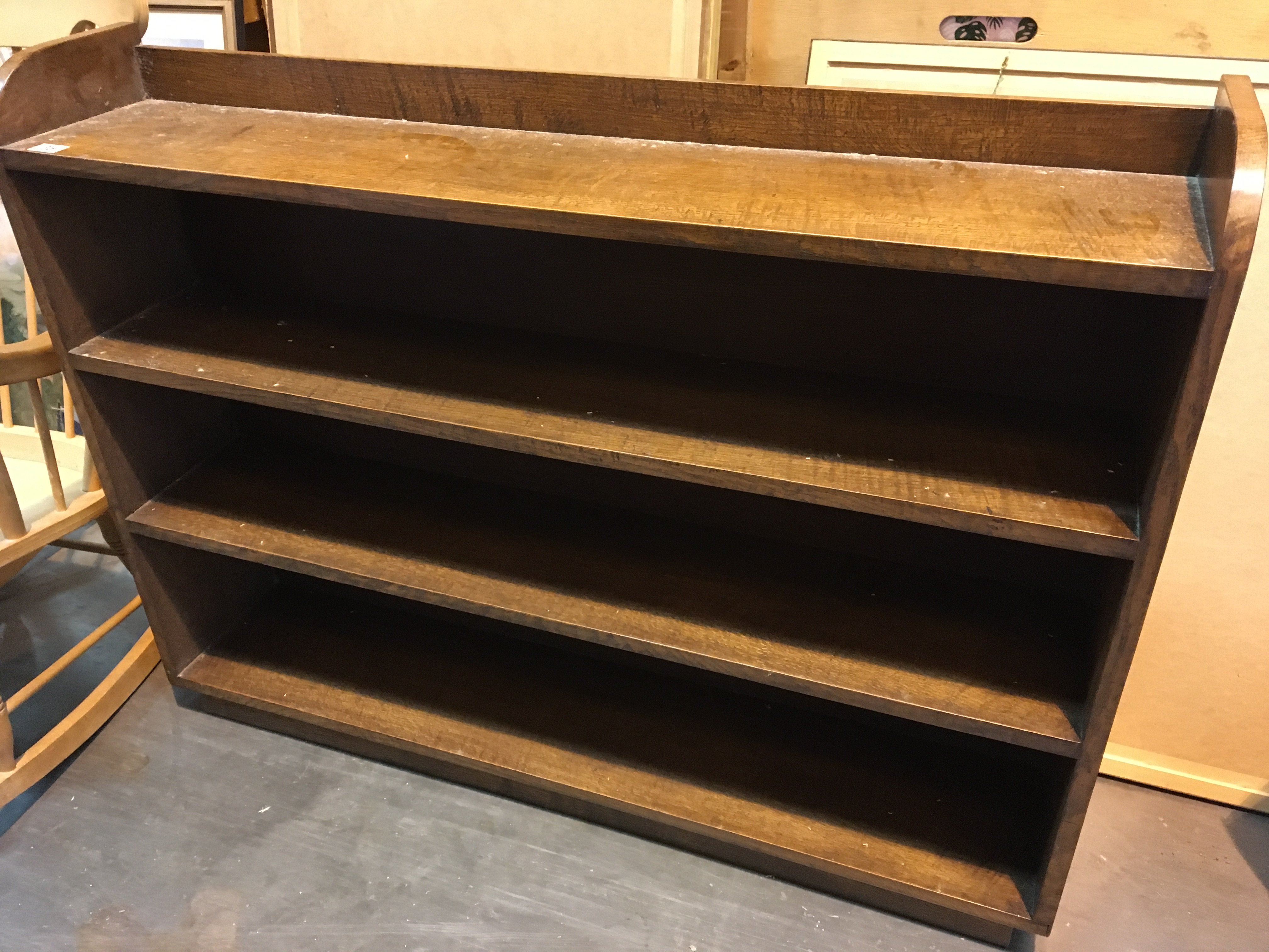 An oak open bookcase with fixed shelves.length 126cm Hight 98cm
