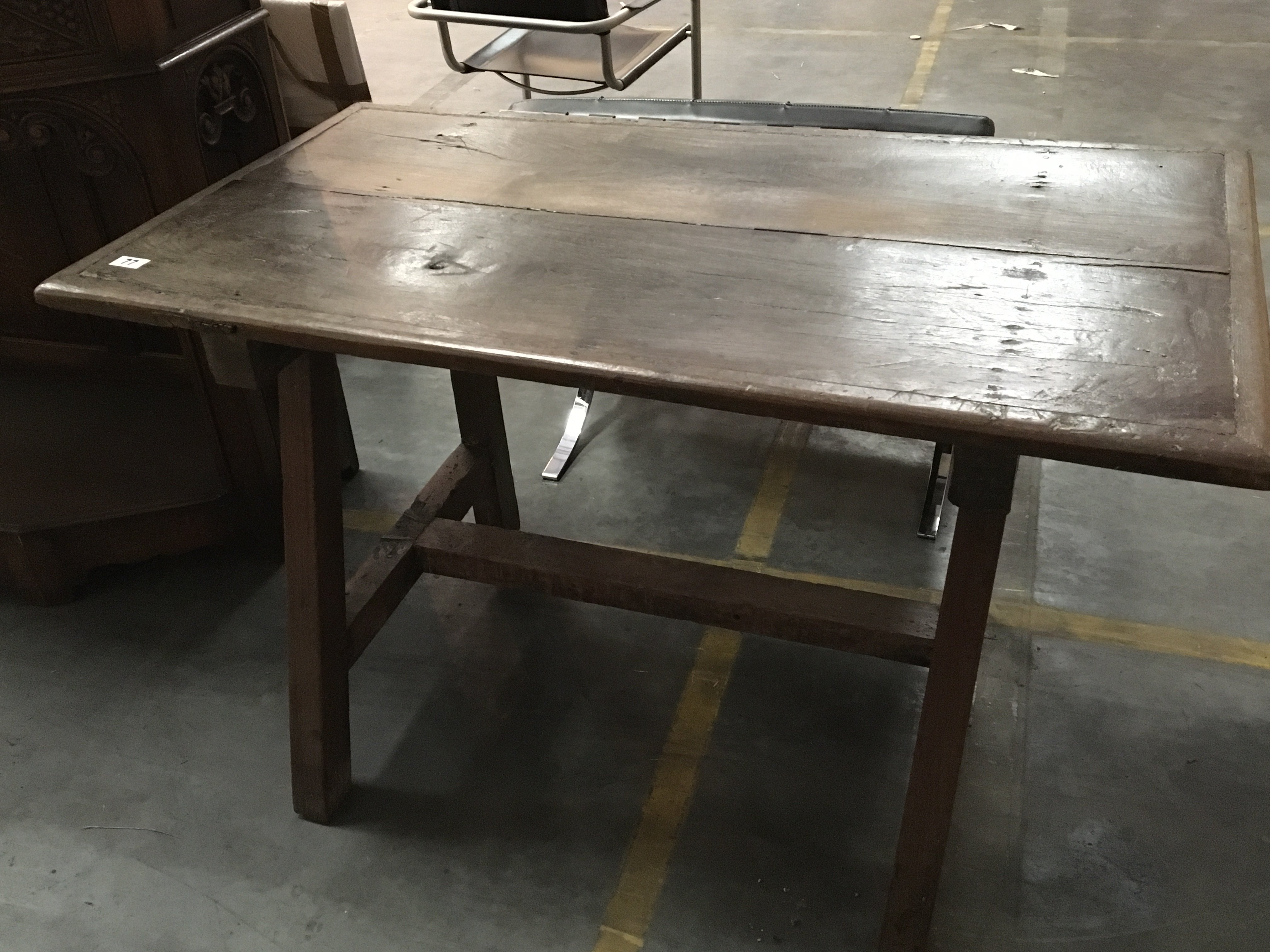 A rustic oak dining table with a rectangular top on splayed square legs.125cm long x 70cm