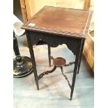 An Edwardian mahogany square top occasional table with blind fretwork.
