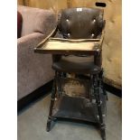 An Edwardian high chair with brown leather seat and turned supports.