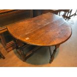 An early 19th century drop oak dining table, with integrated draw to one end. 114 x 130.