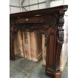 A Quality late 19th century large size mahogany fire surround with carved C scroll and floral