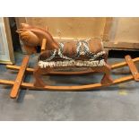 A carved wood rocking horse. Hight 48cm