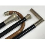 Four walking sticks with silver collars and handle