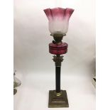 A brass Corinthian column oil lamp with cranberry