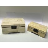 A pair of domed boxes made of bone and lined insid