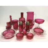 A collection of cranberry glass items.