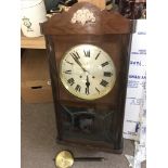 An 8 day mahogany cased wall clock with a silvered