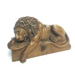 A Quality carved wood sculpture of a Recumbent Lio