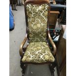 A Victorian Mahogany Rocking chair with upholstere