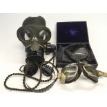 A pair of airman's goggles, gas mask and magnifier