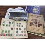 A collection of loose stamps and stamp albums.