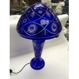 A blue glass table lamp, approx height 58cm.