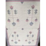 A Dhurrie rug with pink boarders and floral centra