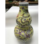 A large yellow Chinese double gourd vase. Top is a