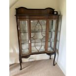 An Edwardian double bow fronted display cabinet wi